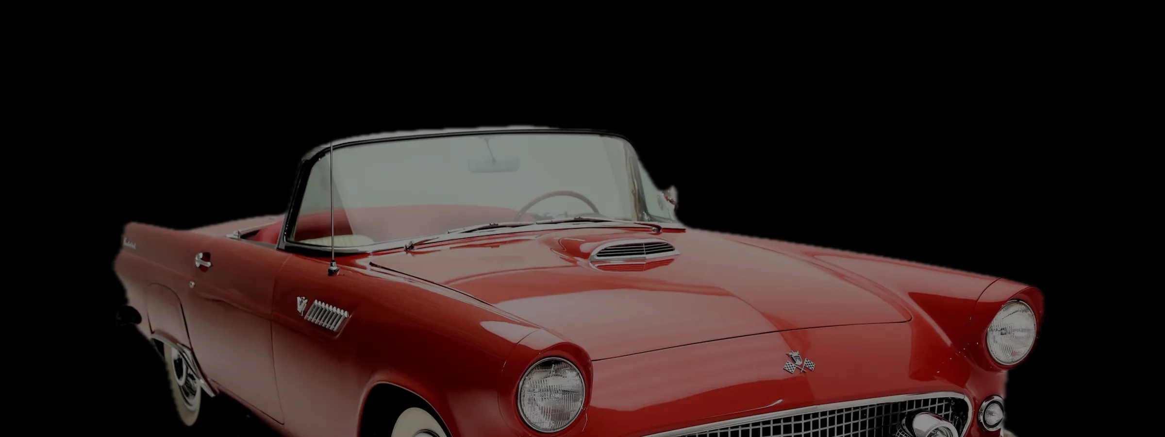 A 1955 Ford Thunderbird convertible in the dark